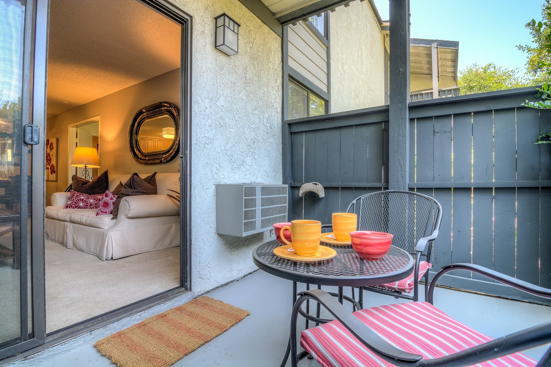 A patio with a table and chairs is shown.,A patio with a table and chairs is shown.